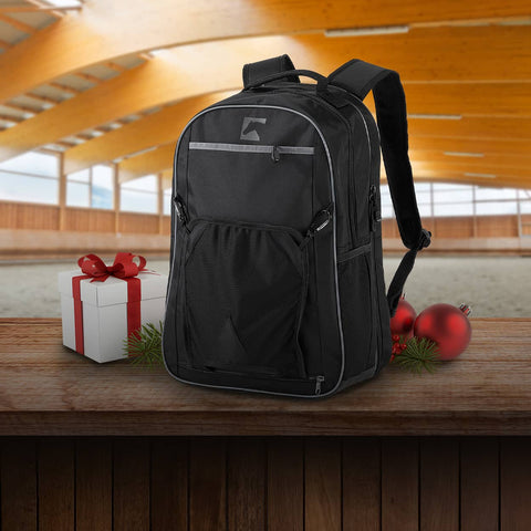 Black backpack on a wooden surface with Christmas decorations in the background
