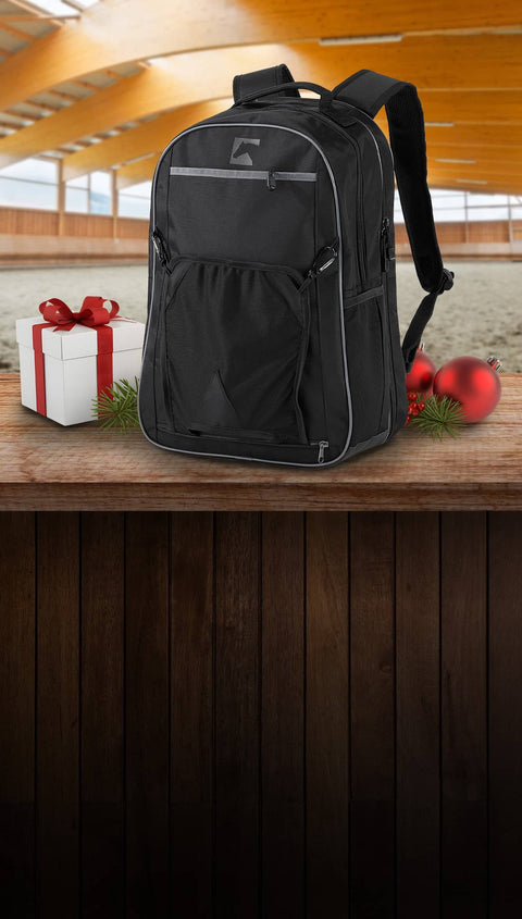 Black backpack on a wooden surface with Christmas decorations in the background