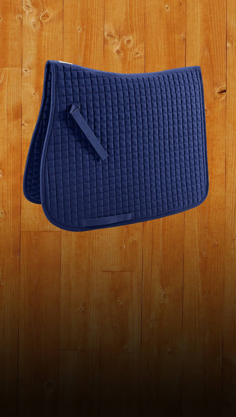 Blue quilted saddle pad on a wooden surface