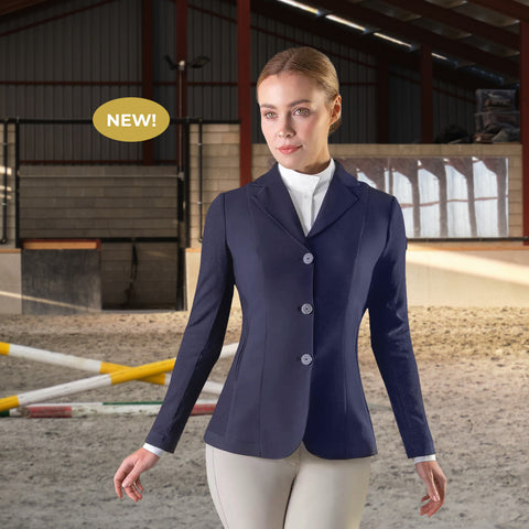 Woman in an indoor arena, wearing a navy three-button competition coat